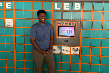 Neo Hutiri in front a set of smart lockers, called Pelebox, which is made by his software development company Technovera.